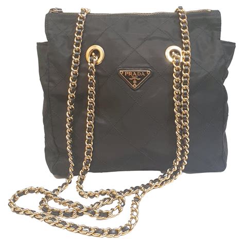 prada black and gold bag.